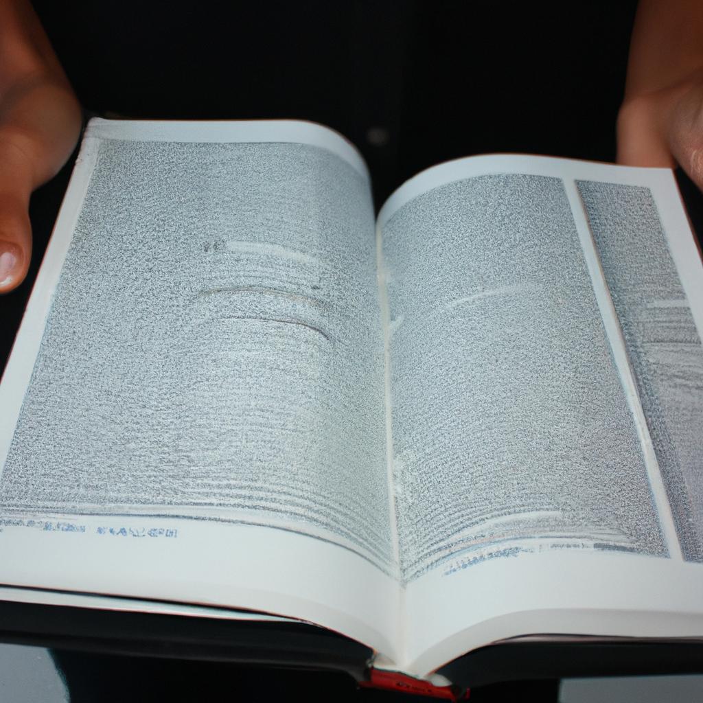 Person holding a textbook, studying